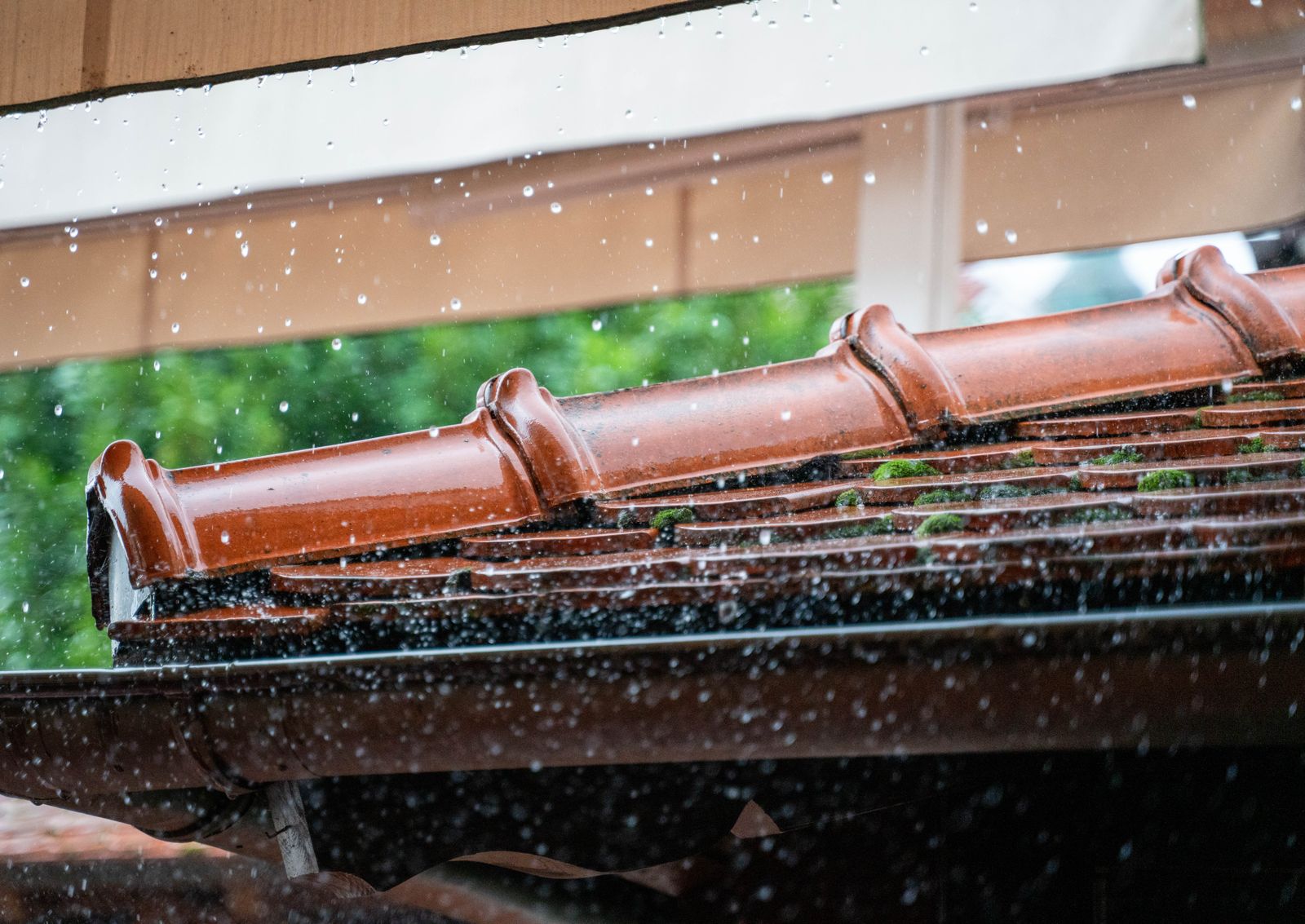 Rainwater running along a roof gutter